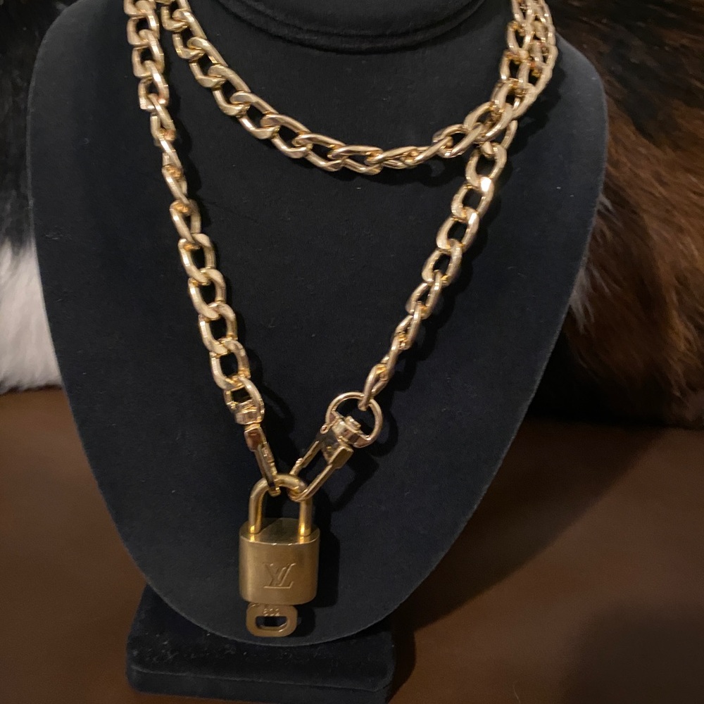 Louis Vuitton gold finish vintage lock/key with 16” gold finish chain.
